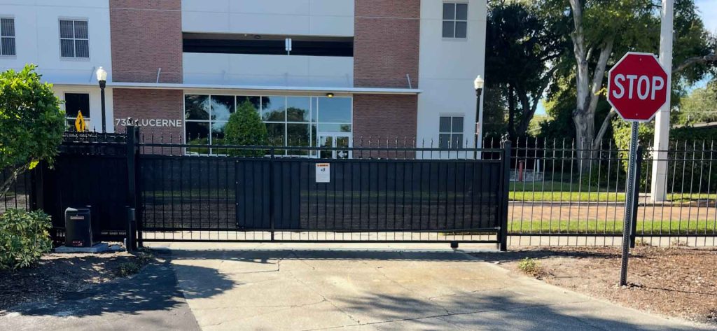 Motorized gate managing entry to parking lot